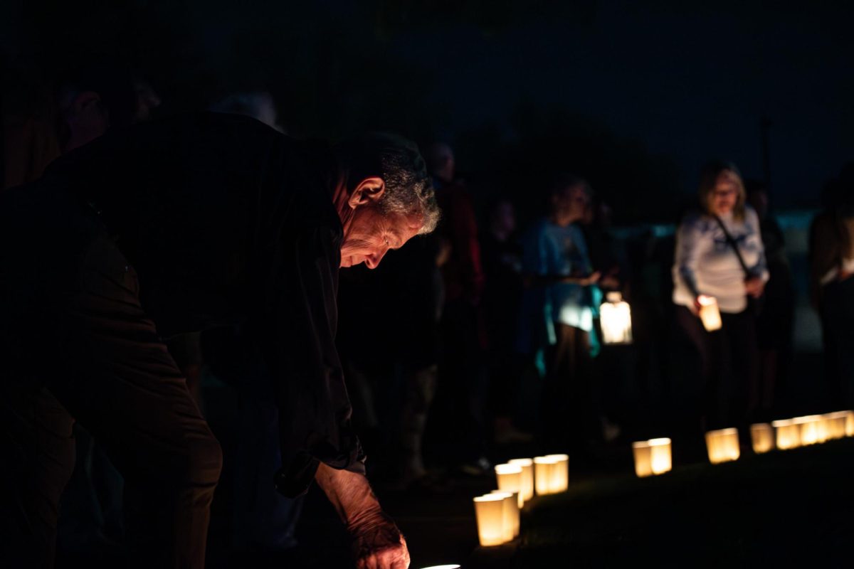 After the walk, participants place their candles in a ring lining the tree in the Taylor Hall parking lot May 3, 2024.