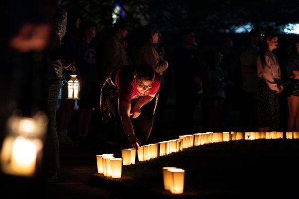 Attendees of the annual Candlelight Walk and Vigil place candles in a ring around the tree in the Taylor Hall parking lot at the end of the walk and the start of the vigil May 3, 2024.