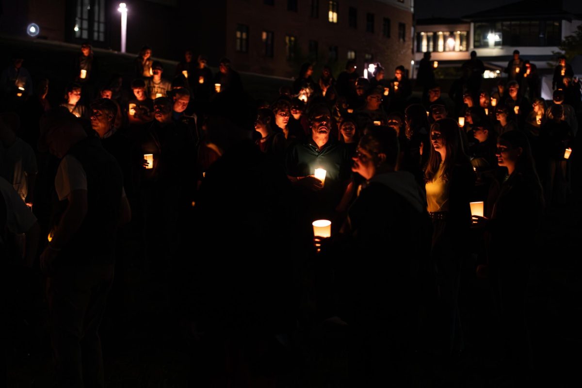 Lit candles in hand, attendees of the Candlelight Walk and Vigil move down the Student Commons toward the Victory Bell to commence the walk across campus May 3, 2024.