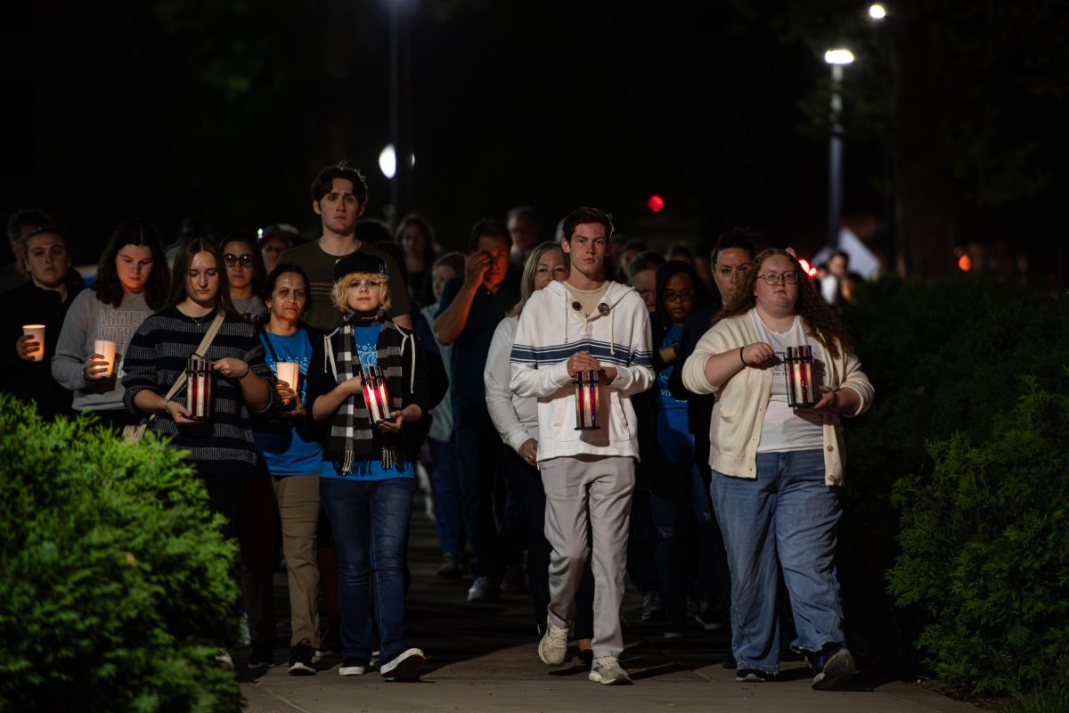 The path of the Candlelight Walk and Vigil takes participants along East Main Street as the travel a circuit of campus with candles in hand May 3, 2024.