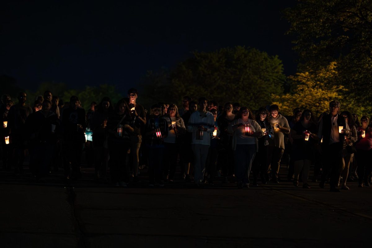 Participants of the Candlelight Vigil and Walk crest the hill of Midway Drive as they return to Taylor Hall in the last stretch of the circuit around campus May 3, 2024. 