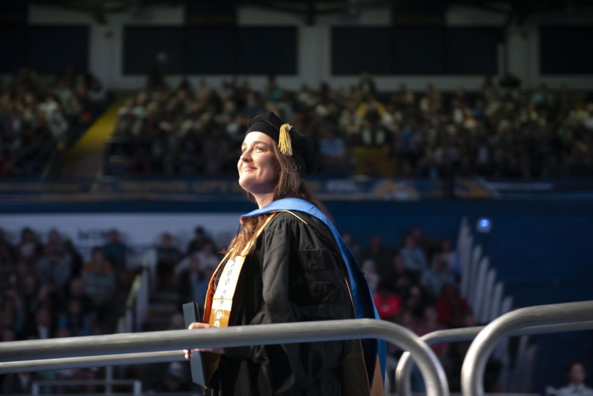 A graduate walks the stage on May 9, 2024, at the masters, educational specialist and doctoral commencement in the Memorial Athletic and Convocation Center.