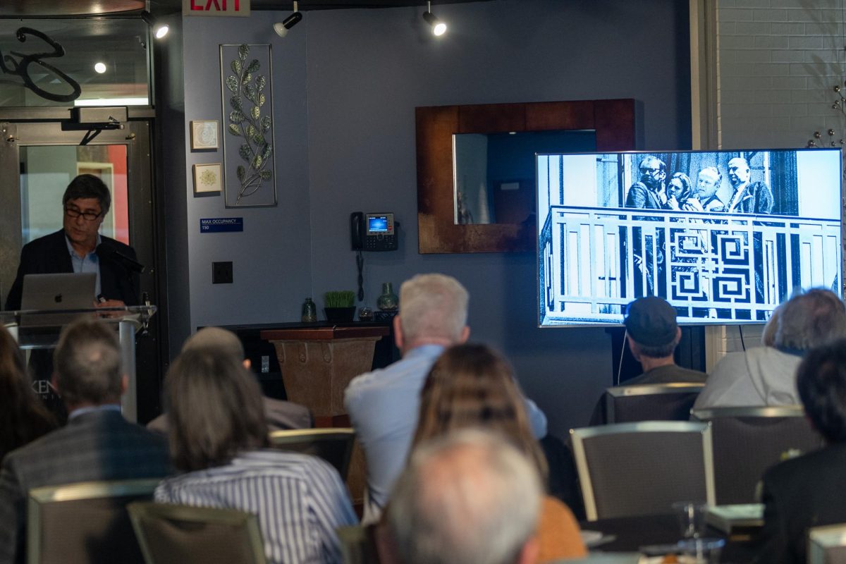 Author Lawrence Roberts explains the picture to the audience during the Voices of Democracy presentation on May 3, 2024.