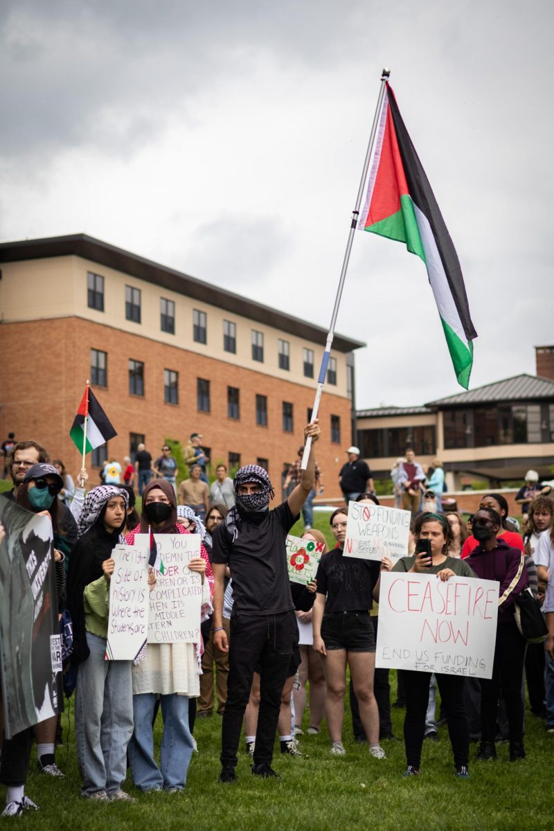 People hold signs and flags during a protest for Palestine on May 4, 2024.