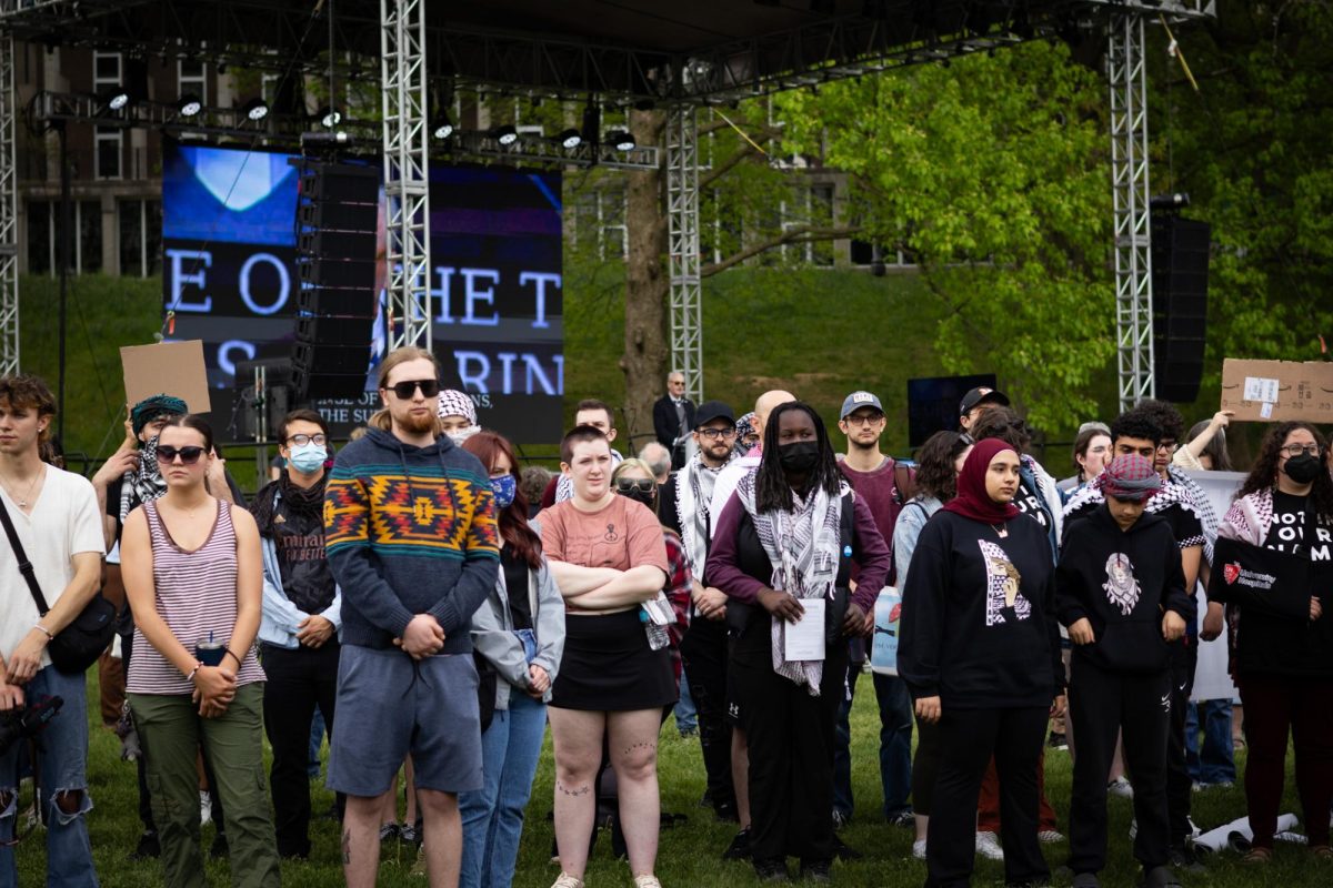 People who support Palestine turn away while President Todd Diacon speaks during the May 4 Commemoration on May 4, 2024.