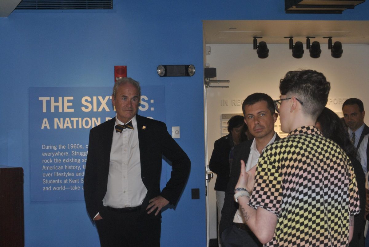 U.S Transportation Secretary Pete Buttigieg and  Kent State President Todd Diacon listen to student employees guide them through the May 4th museum. 