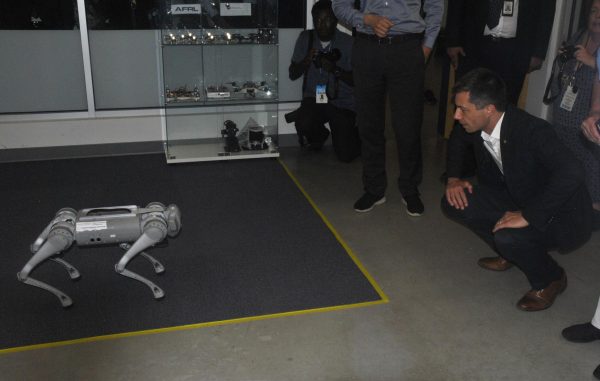 U.S Transportation Secretary Pete Buttigieg interacts with a robotic dog in the Cognitive Robotics and AI Laboratory on Monday, June 24, during a visit to Kent State.