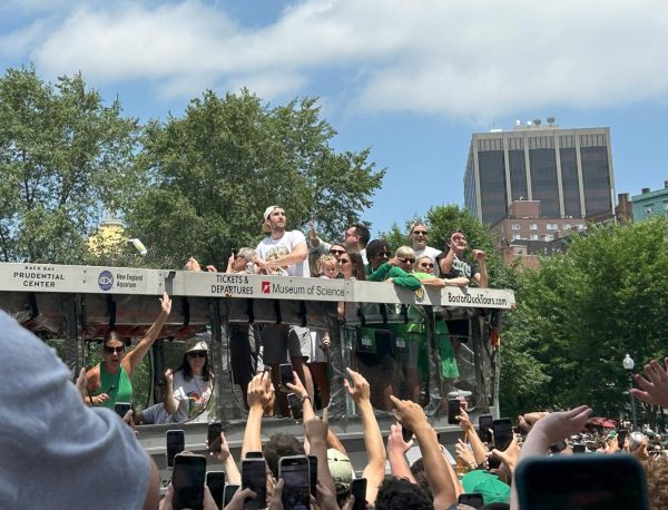 Celtics Center Luke Kornet sits on top a duck boat at the Celtics championship parade in downtown Boston on Friday.
