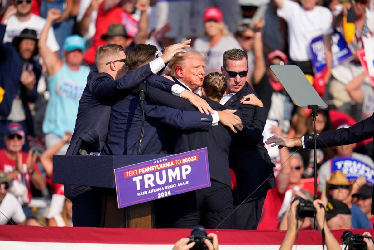 Republican presidential candidate former President Donald Trump is helped off the stage at a campaign event in Butler, Pennsylvania, on Saturday, July 13.