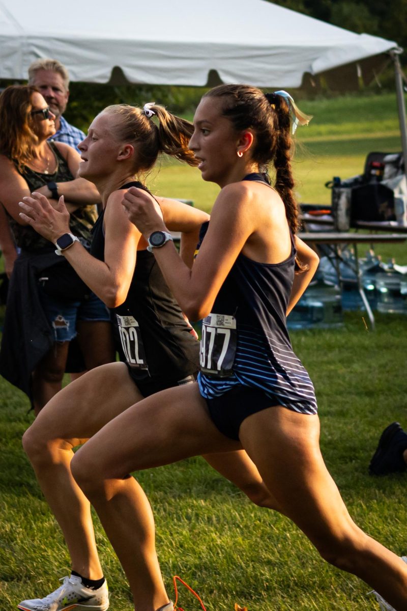 Alexis Tracy passes someone as they approach the finish at the cross country race where she will finish 68th on August 30, 2024.