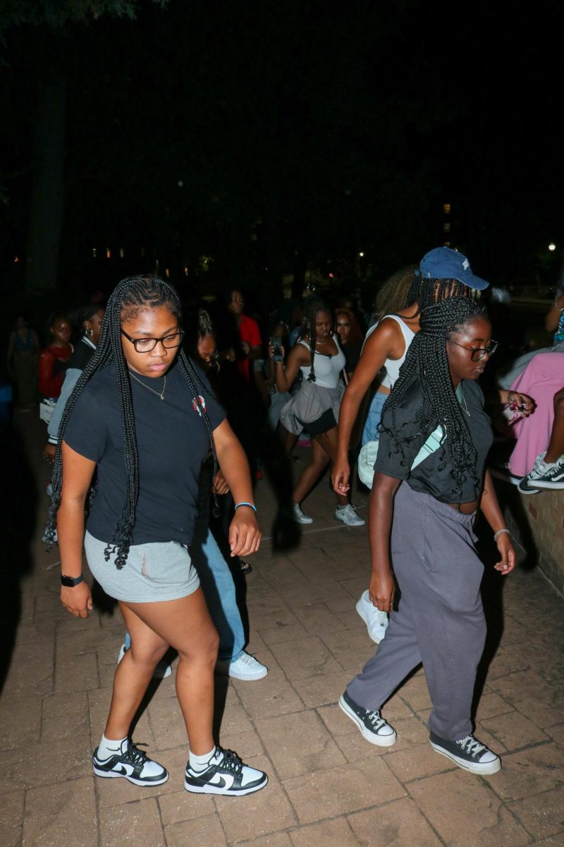 Students line dance together at BUS's Block Party in celebration of the new fall semester outside of Oscar Ritchie Hall at Kent State University on August 29th, 2024. 

