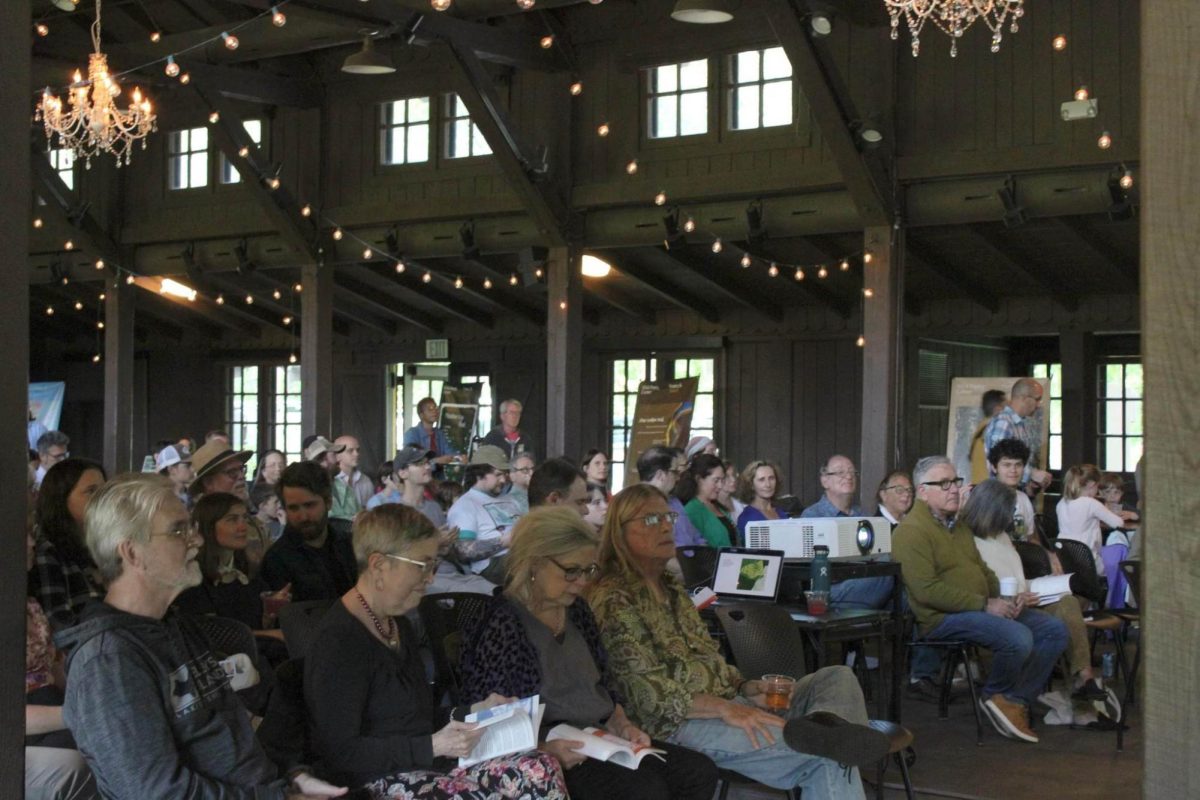 Community members gather to listen to poetry readings at the release of "Light Enters the Grove."