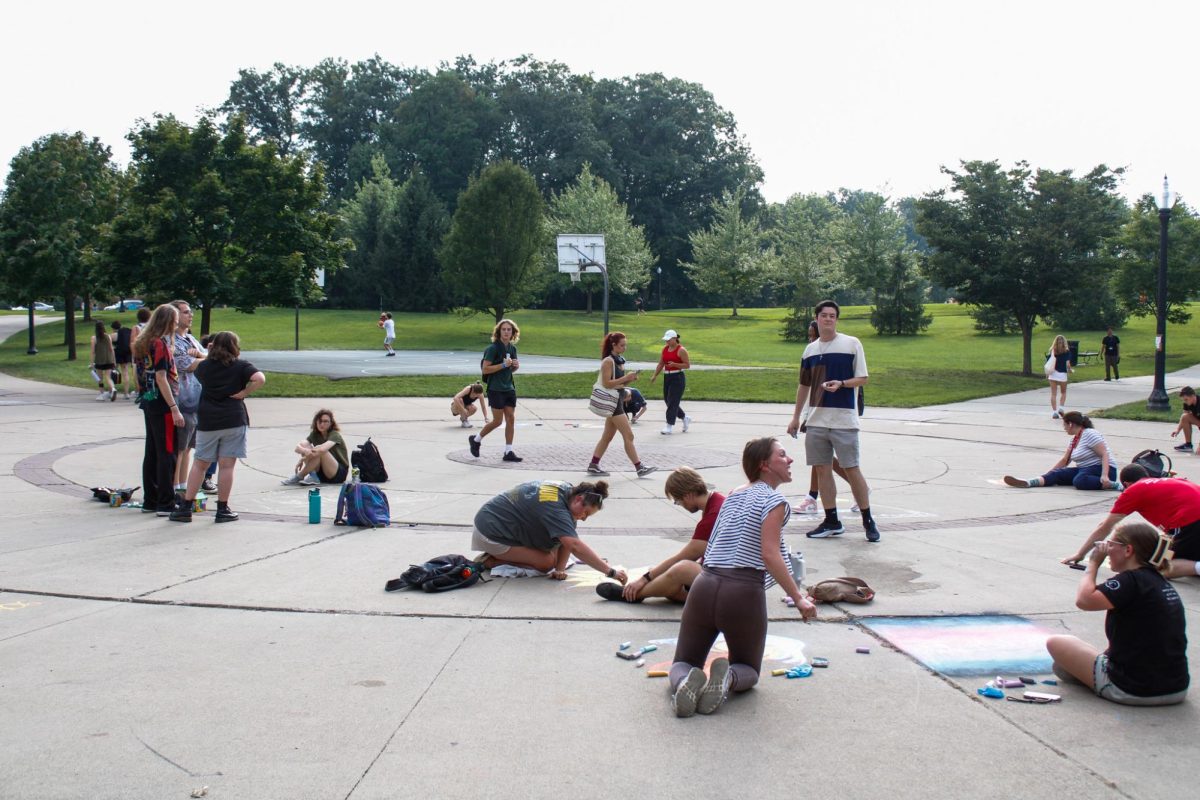 Students gather outside the Tri-Towers Rotunda to take part in the Chalk Competition organized by Victoria Glover and Nathan Loughry on Aug. 26, 2024.