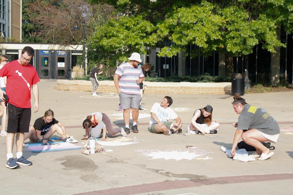 Students gather outside the Tri-Towers Rotunda to take part in a chalk-art competition organized by Victoria Glover and Nathan Loughry on Aug. 26, 2024.