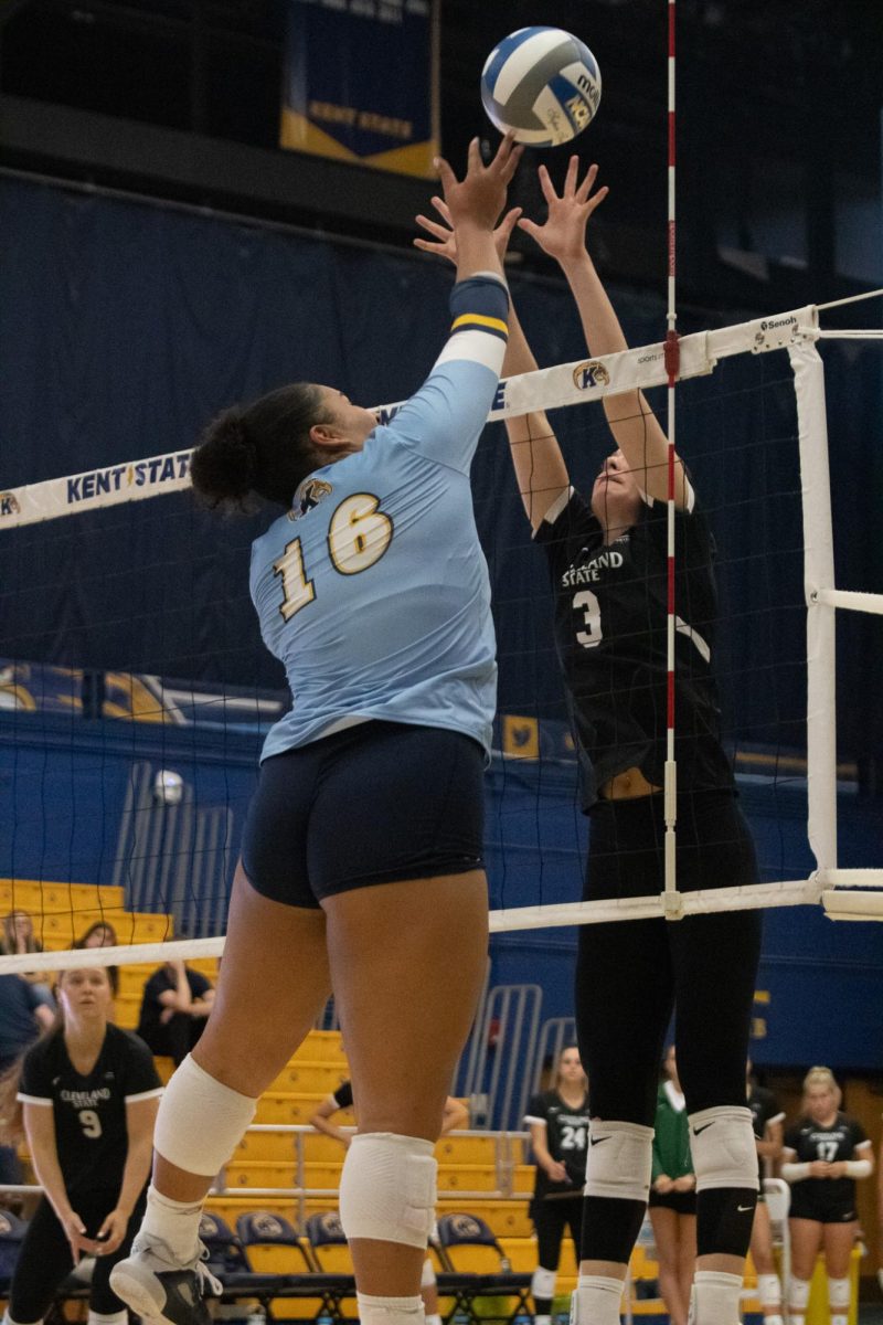 Kent State Senior Chelsea Harvey takes to the air to tip the ball over blocker CSU Player Liberty Torres on Sep. 19, 2024.