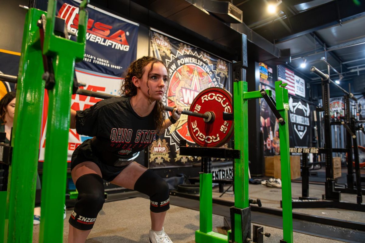 Kent senior biochemistry major Maria Sargent squats at Kent Barbell Club, Wednesday, Sept. 25, 2024.