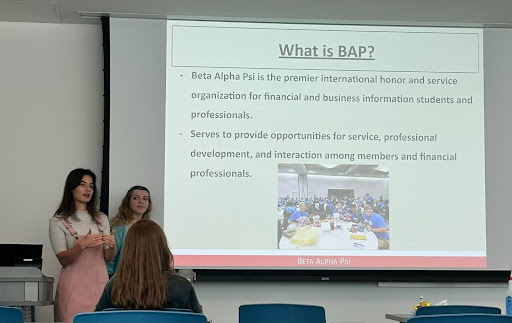 Beta Alpha Psi officers Anna Siesel and Kayla Nagle speak to students about membership requirements Sept. 18 during a fraternity meeting.