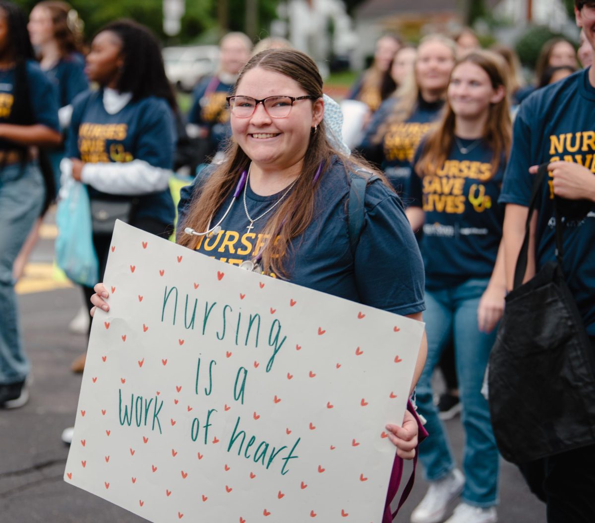 The Kent State Nursing Student show off their signs as they walk in the Homecoming parade, Sept. 28, 2024.