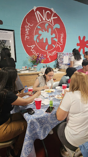 Students share dinner during a game night on Aug. 31 at International Navigators Collegiate's Fine Arts Studio.