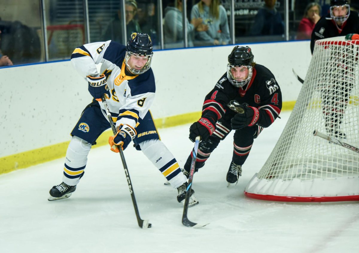 Cole Bianchin, Kent State freshman and forward, defends the puck in the third period against Northern Illinois Defensemen and Senior Keaton Peters, Sept. 14th, 2024.