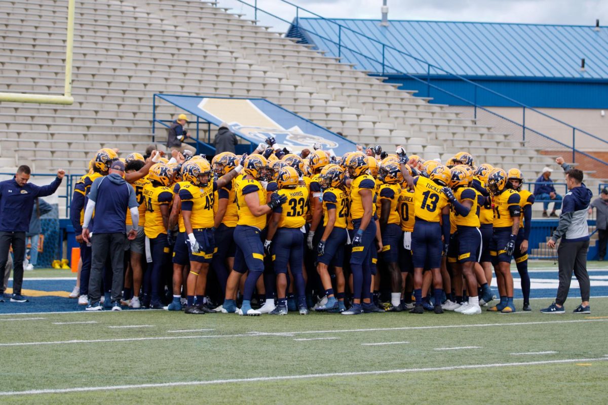 Kent State Football players and coaches huddle before their home game against Saint Francis University on Sept. 7, 2024. 