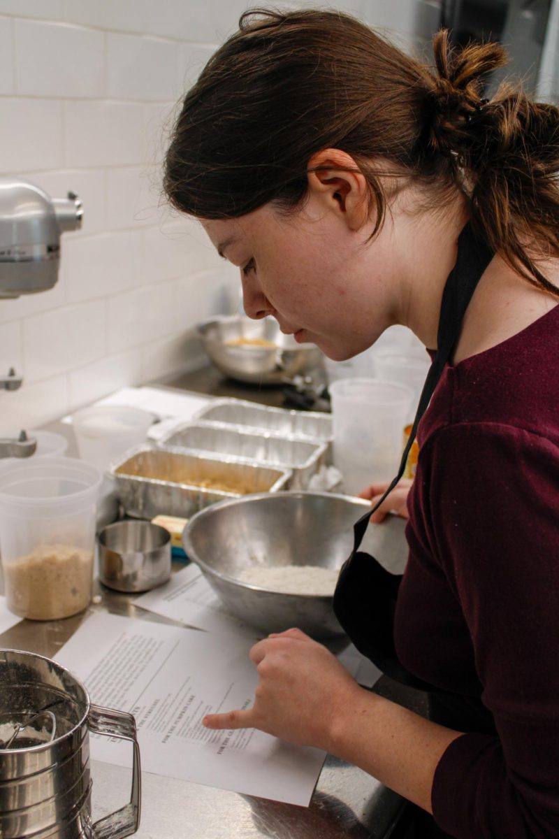 Senior, Sammy Wise reads a recipe for pumpkin crumb cake during a culinary class in the DI Hub on September 13, 2024.