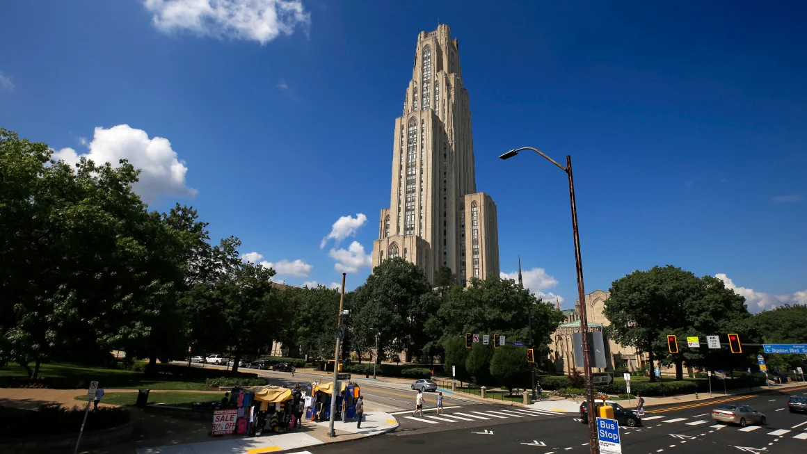 The Cathedral of Learning towers over the University of Pittsburgh campus in Pittsburgh's Oakland neighborhood Monday, July 8, 2019.