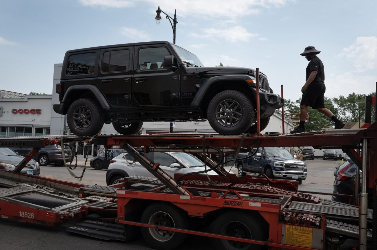 Jeep vehicles are delivered to a dealership on June 20 in Chicago.