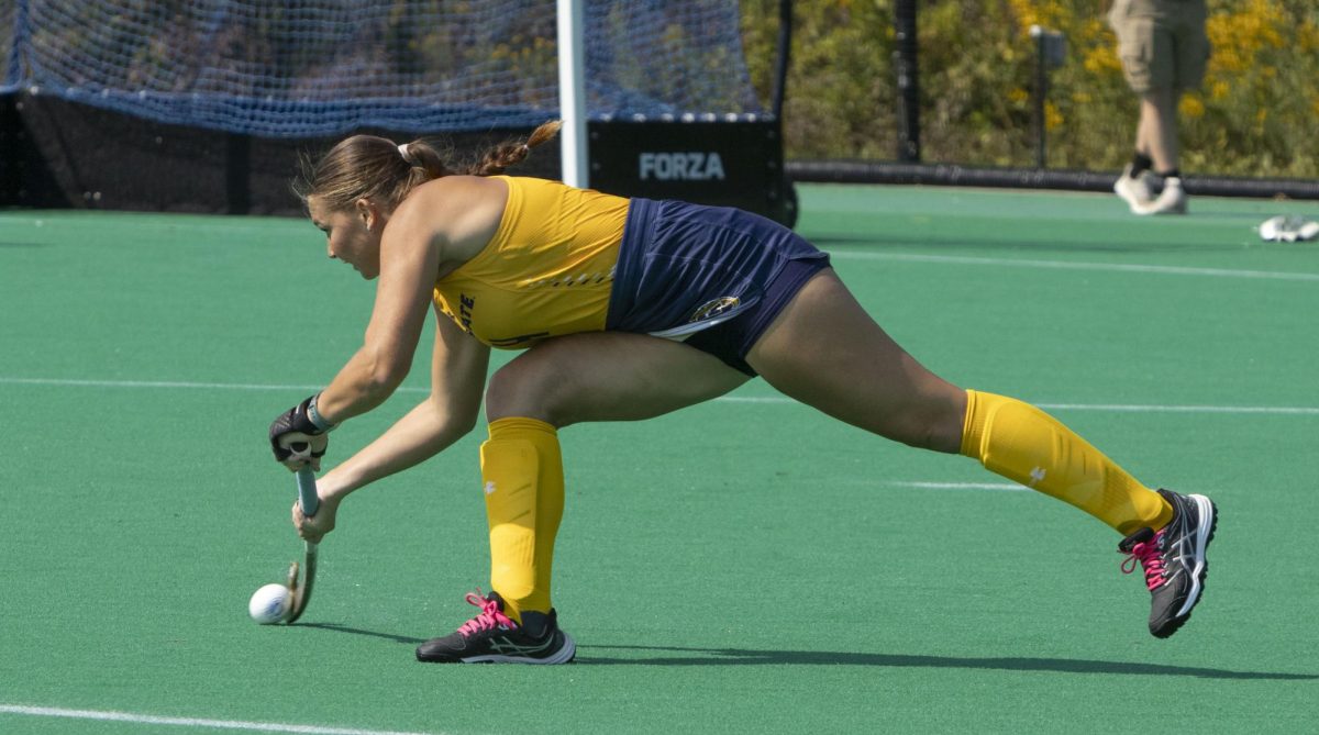 Senior backer Elise Bearance (4) shoots down the pitch at the field hockey game against Penn State, Sept. 13, 2024.