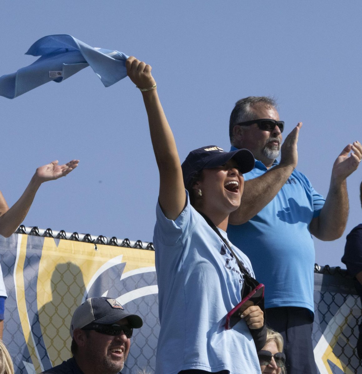 A student waves a 50th anniversary rally towel as the Golden Flashes score a point during the Sept. 13, 2024 field hockey game against Penn State.