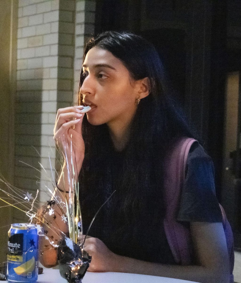 A student eats a cookie after the PRSSA Kent and Kent AAF Icons and Influencers event, Sept. 18, 2024.