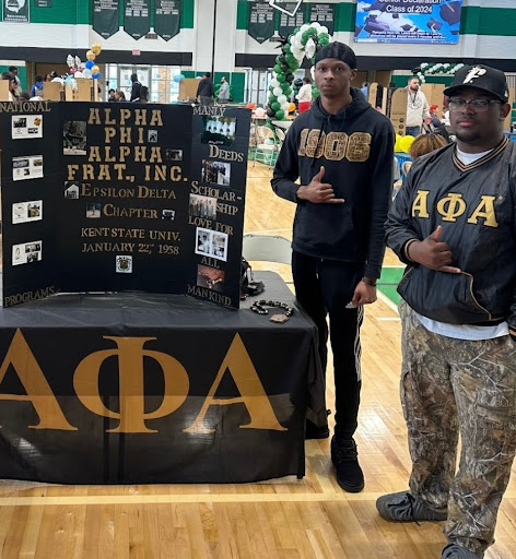 Alpha Phi Alpha treasurer Isaac Britten (left) and vice president Greg Simpson attend a recruitment event at Bedford High School in April.