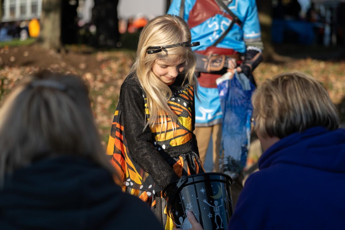 Allison, an 8-year-old dressed in a butterfly costume, got candy at the Halloween party on Oct.  25, 2024.