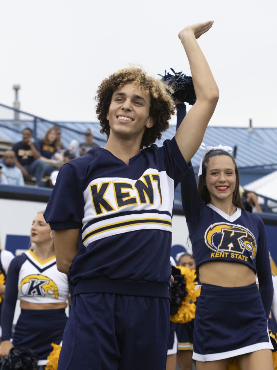 Kent State cheerleader waves to the crowd at the Homecoming football game against Eastern Michigan, Sept. 28, 2024.