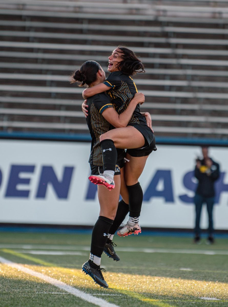 Jules Dolinski, Kent State freshman and forward, celebrates with teammate Alanna Raimondo after she scores the first goal of the game against Western Michigan. Oct. 5, 2024.