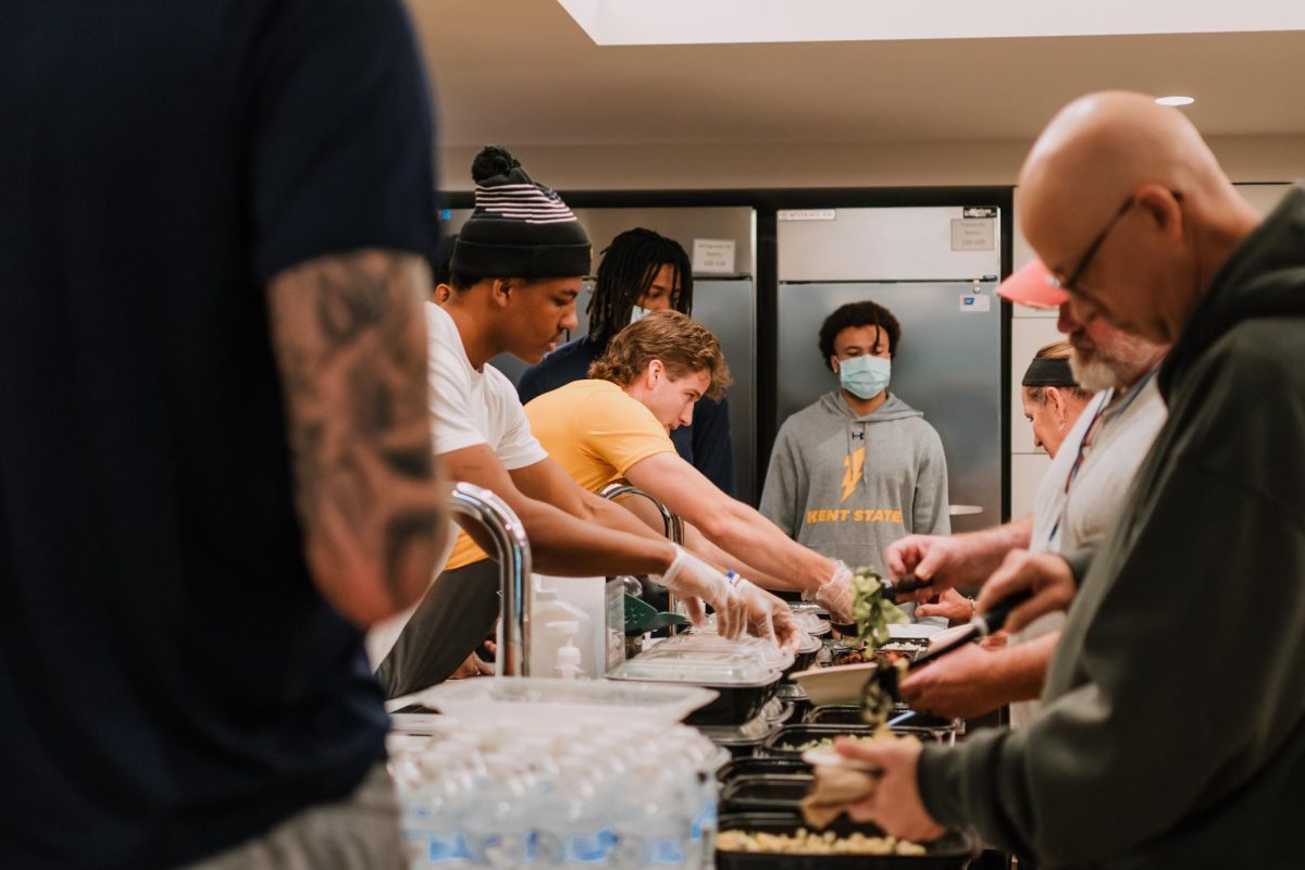 Members of the men's basketball team serve food at the Coaches vs. Cancer event Sept. 11, 2024.