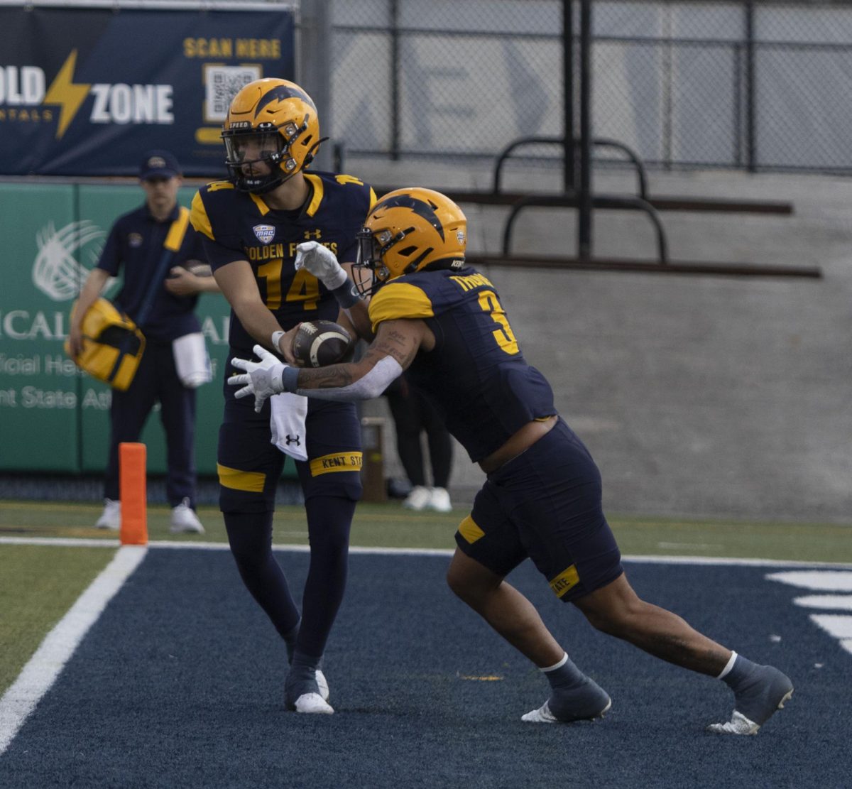 Freshman quarterback Tommy Ulatowski (14) makes a handoff to senior safety Dean Clark (3) at the Oct. 12, 2024 football game against Ball State University.