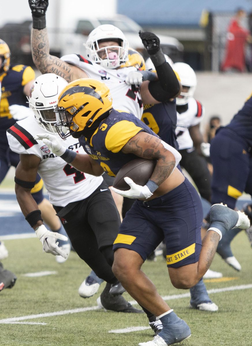 At the Oct. 12, 2024 football game, redshirt senior running back Ky Thomas dodges a Ball State University defender.