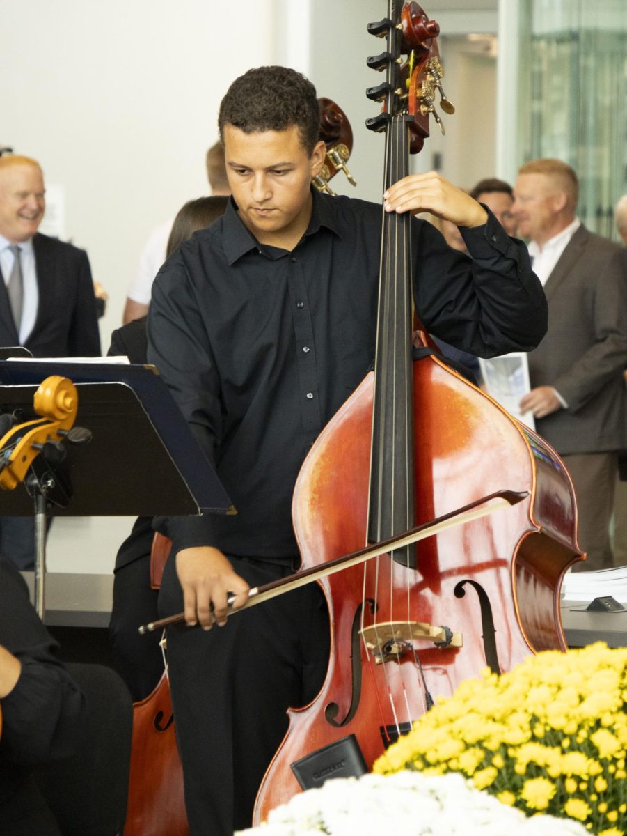 Prior to his performance at the Sept. 27, 2024 Crawford Hall grand opening, a member of the Kent State symphony warms up his instrument.