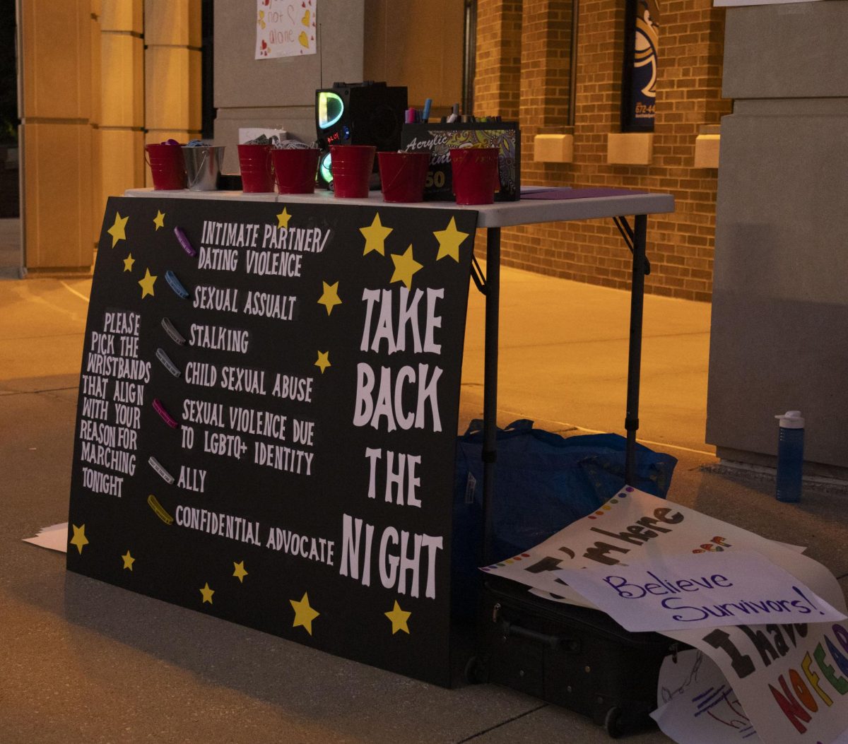 Bracelets are offered to marchers to show their support for various aspects of sexual and domestic violence at the Take Back the Night march, Oct. 8, 2024.