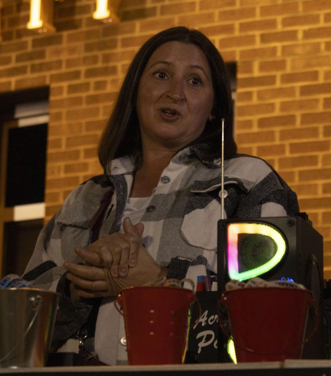 At the Take Back the Night march, Associate Director of Safer Futures, Anne Face, shares various resources for victims of sexual and domestic violence, Oct. 8, 2024.