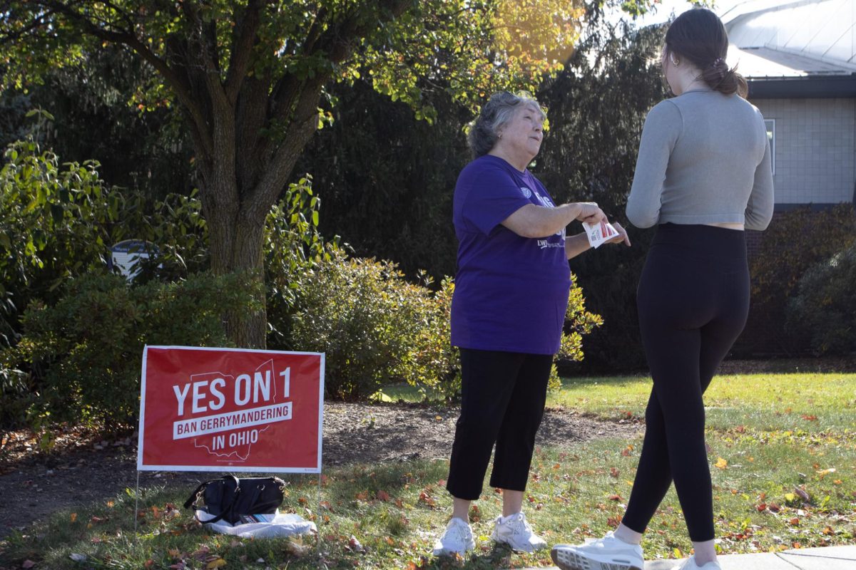 Alberta Bowman informs a voter about details of the Issue 1 ballot before going in to vote Nov. 5, 2024. 