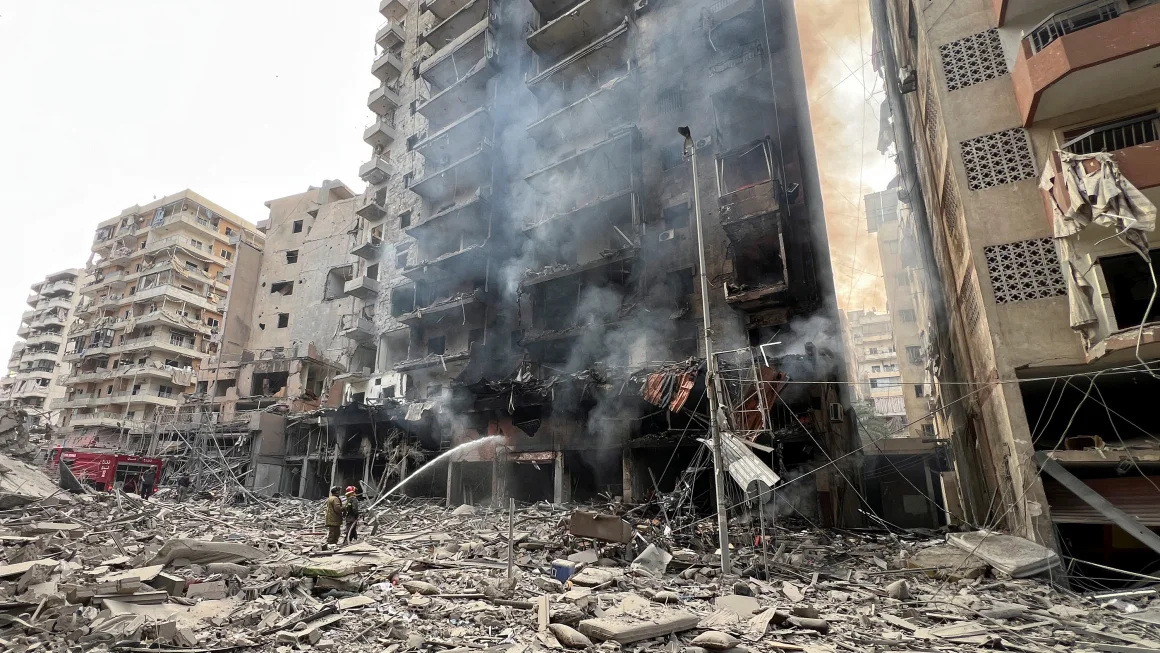 Firefighters work at a damaged site, in the aftermath of Israeli strikes, in Beirut's southern suburbs on November 9, 2024.