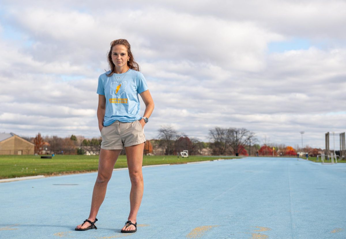 Kent Cross Country Head Coach Laura Rybka stands for portrait on the outdoor track, Nov. 7, 2024. 