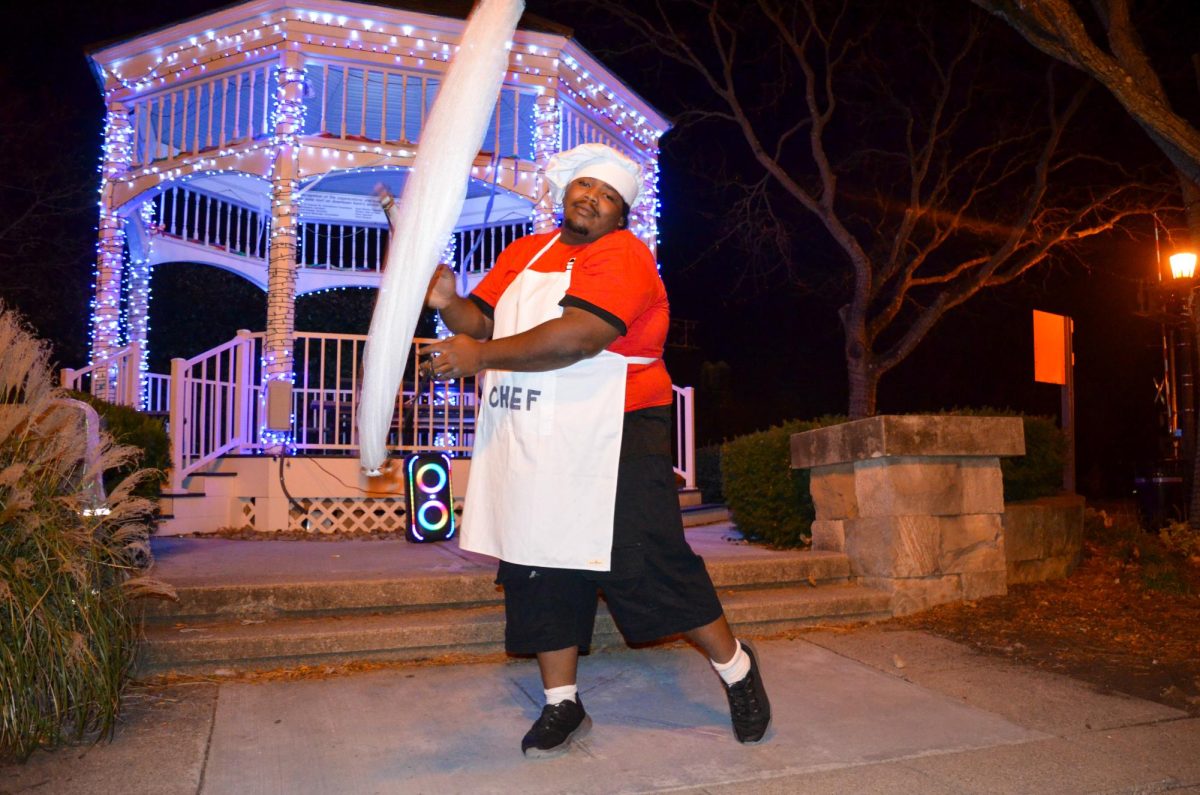 Jordan Davis-Lindsay, dressed as a chef, cooks up ribbon dances for tips in downtown Kent, Ohio, on November 2, 2024. 