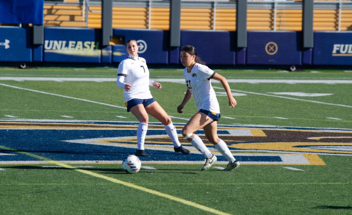 Kent State player Katie Henahan prepares to punt ball across field during game against Miami University on November 3, 2024. 