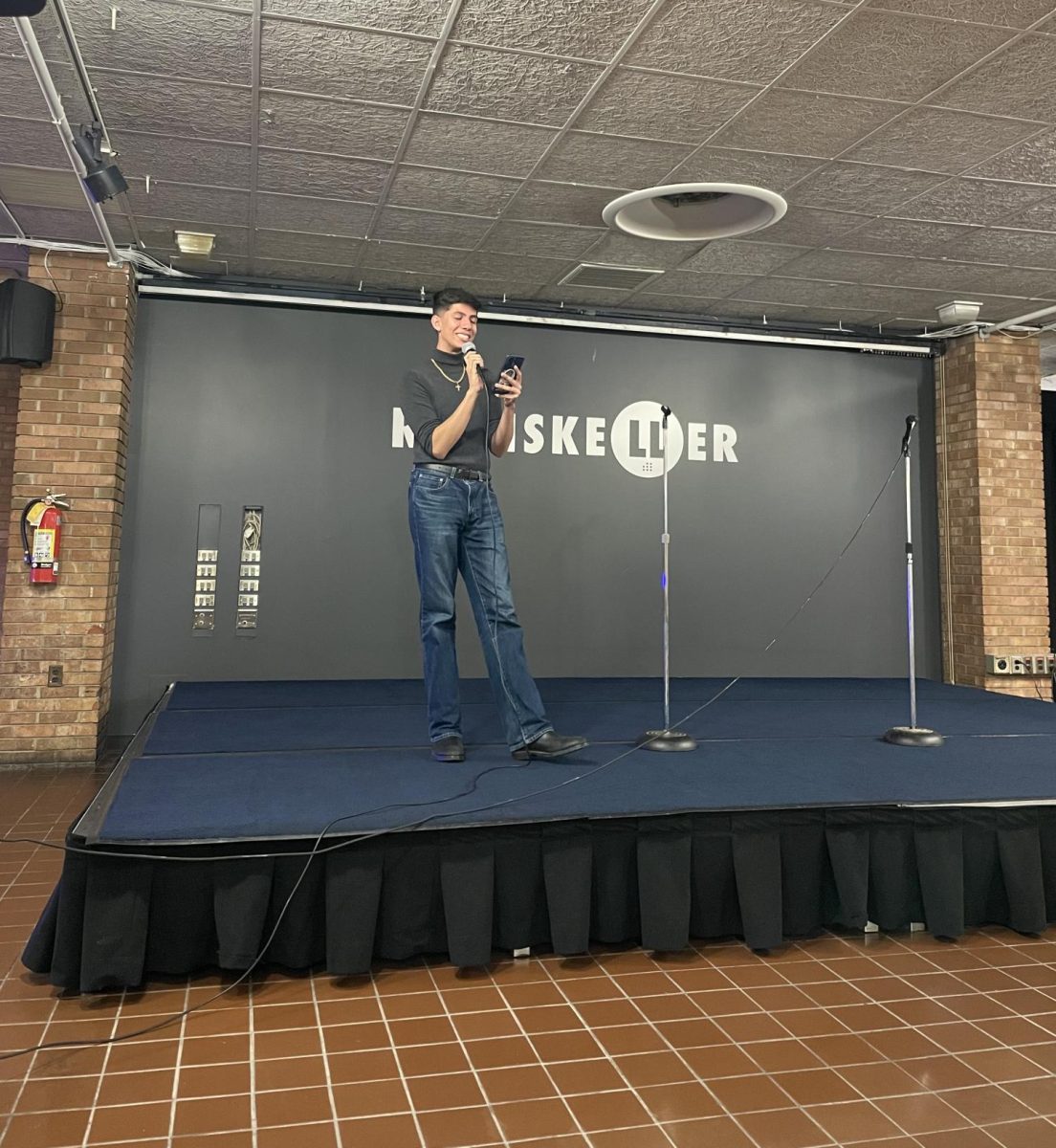 USG's College of Communication and Information senator Dennis Farahani reads poetry at the Poetry Slam Showcase Nov. 4, 2024.