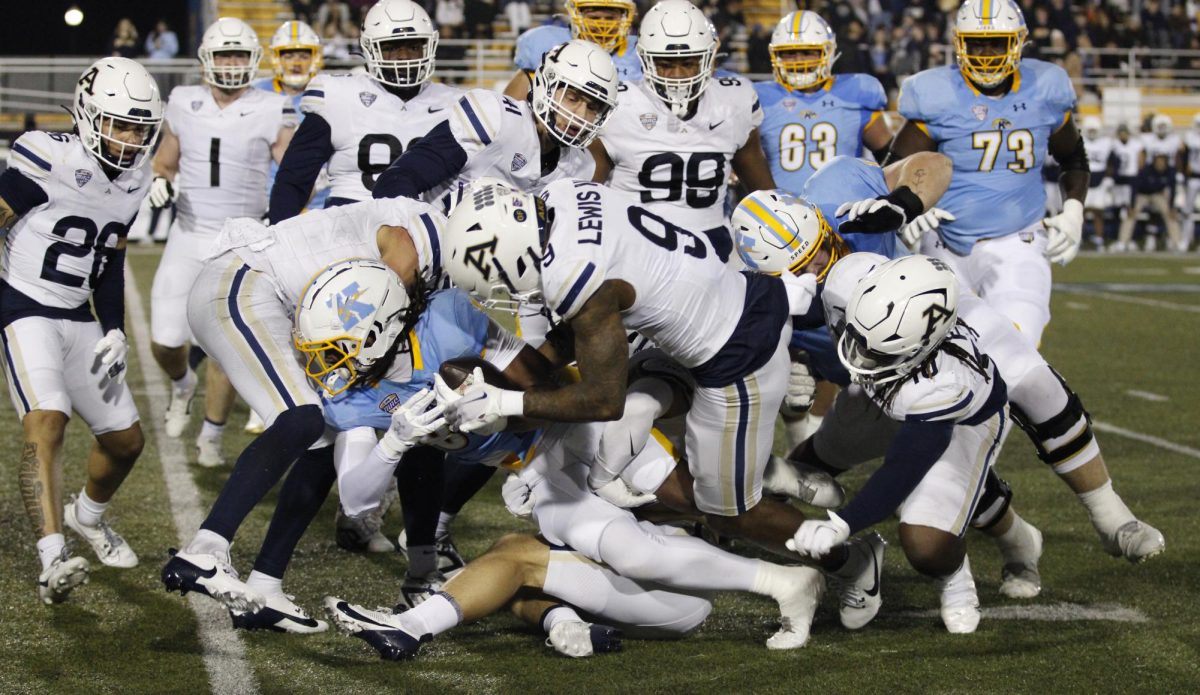 Kent State University player gets tackled during a play against Akron University players during their rival game on November 19,2024.  