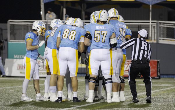 Kent State Football huddled up for a quick talk before the start of the first quarter in their rival match against Akron on November 19,2024. 